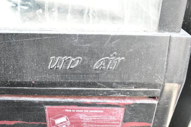 Turbo Air commercial deli display case; black exterior with Turbo Air logo. Visible wear; cleaning instructions label attached.