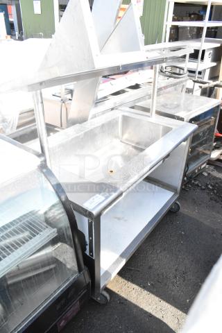 Commercial ice bin buffet station with stainless steel construction on commercial casters. Features sturdy design, used condition.