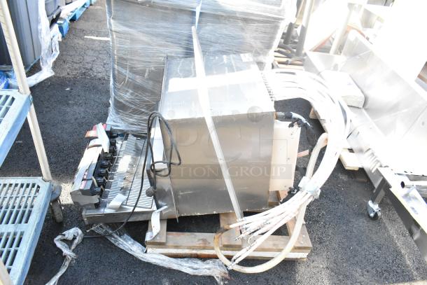 Commercial 8-flavor carbonated beverage machine on drop-in ice bin, includes dispensing hoses and control panel, wrapped for transport.