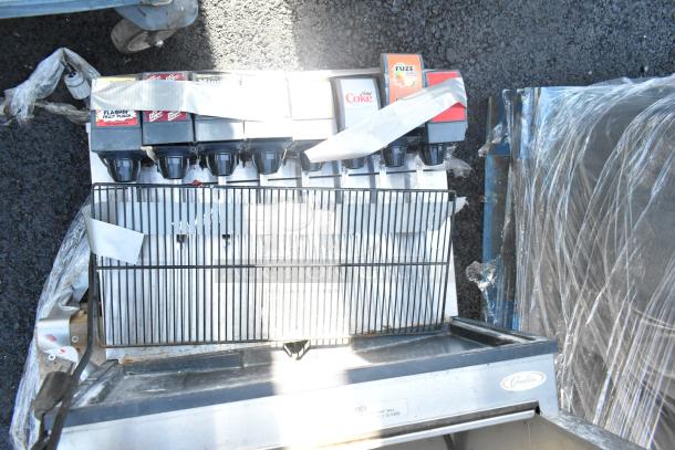 Commercial 8 Flavor Beverage Machine on drop-in ice bin, features multiple drink options. Good condition, visible brand "Cornelius."