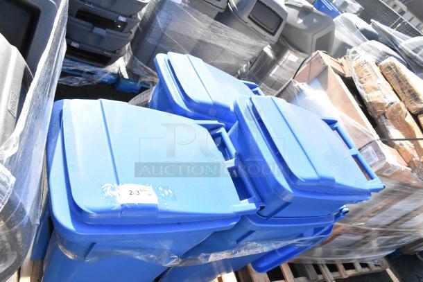 Set of four blue poly trash cans on pallet; durable with secure lids. Marked with auction label "2/3 324 x4".