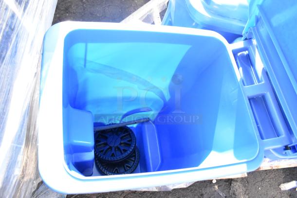 Blue poly trash can with lid, wheels, inside view. Durable plastic. Bid for set of four cans. Ideal for waste management.