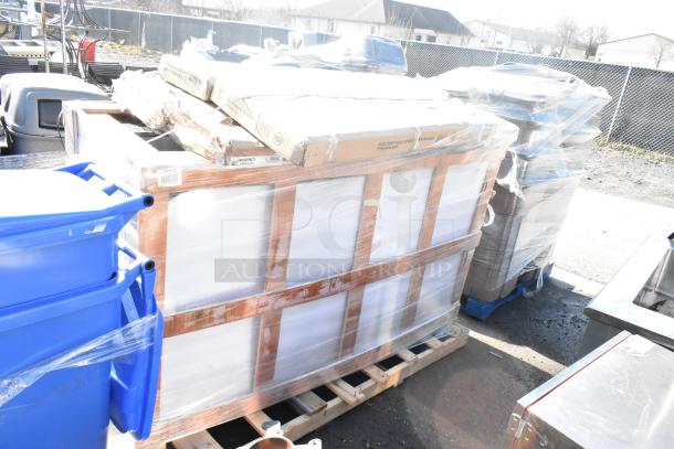 Four brand new scratch and dent items wrapped on a pallet, including an over shelf. Packaging shows minor wear.