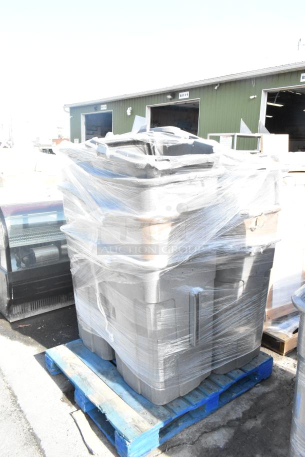 11 Toter gray poly trash can shells, shrink-wrapped on a pallet, showing durable construction and stackable design.