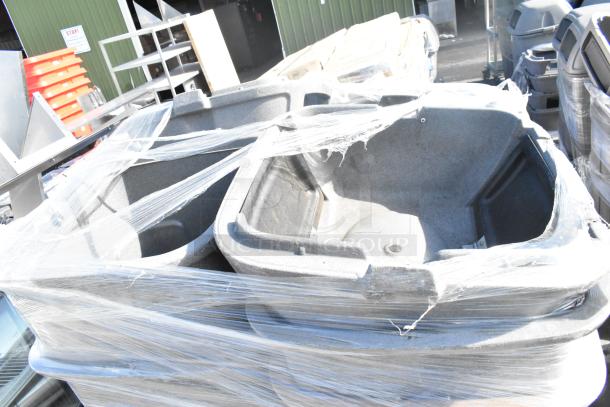 11 Toter gray poly trash can shells, stacked and wrapped in plastic, used condition. Sale includes 11 units.