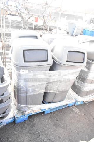 Four gray Toter poly trash can shells wrapped on a pallet. Durable construction, perfect for large waste needs.