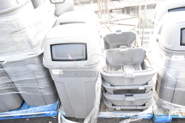 9 Toter gray poly trash can shells on pallets, stackable design, durable construction. Multiple units available, sold collectively.