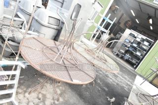 4 round mesh patio tables, metal construction, sturdy design. Used condition, minor wear visible. Outdoor setting.