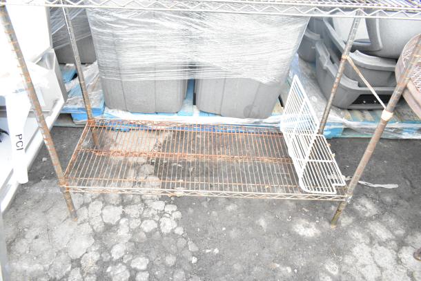 Chrome finish 3-tier wire shelving unit with rust visible on the lower shelf. Buyer must dismantle for shipping.