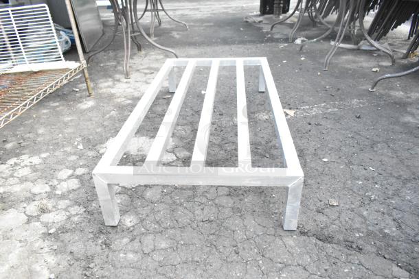 Metal dunnage rack, sturdy construction, slightly worn, suitable for storage and organization needs.