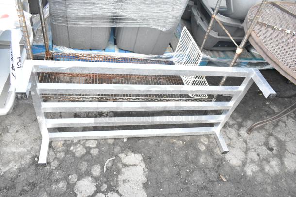 Stainless steel dunnage rack with horizontal slats, in used condition. Ideal for storage, sturdy construction.