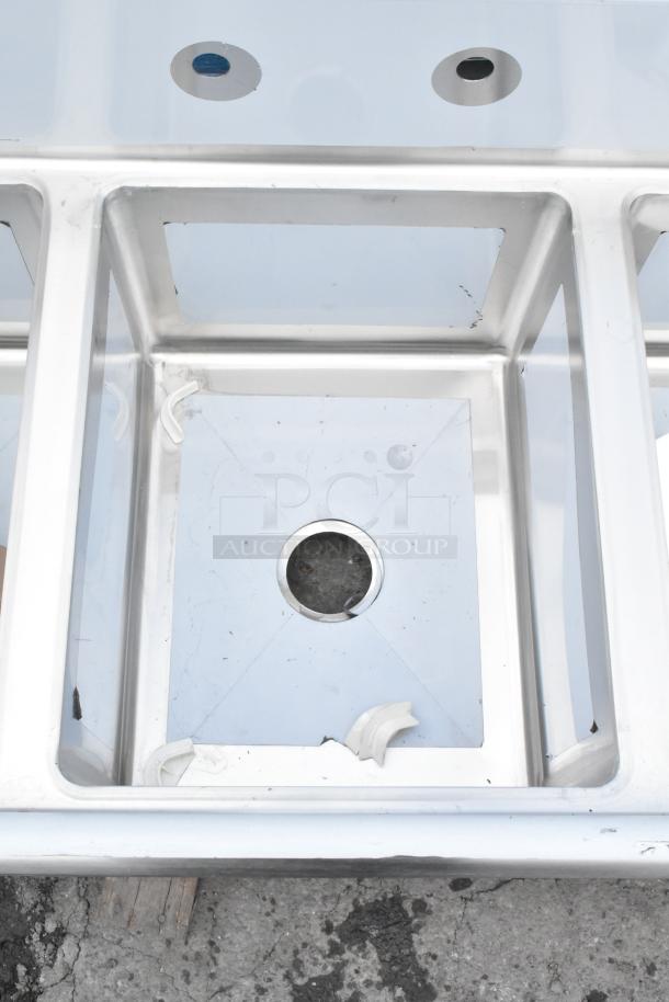 BRAND NEW Regency 600S31620218 three-compartment stainless steel sink with 2 drainboards, galvanized steel legs, scratch and dent.