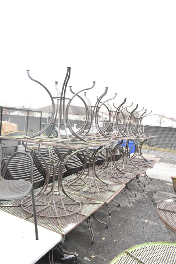 16 metal mesh patio tables stacked outdoors, rust-resistant, weatherproof, perfect for garden setups.