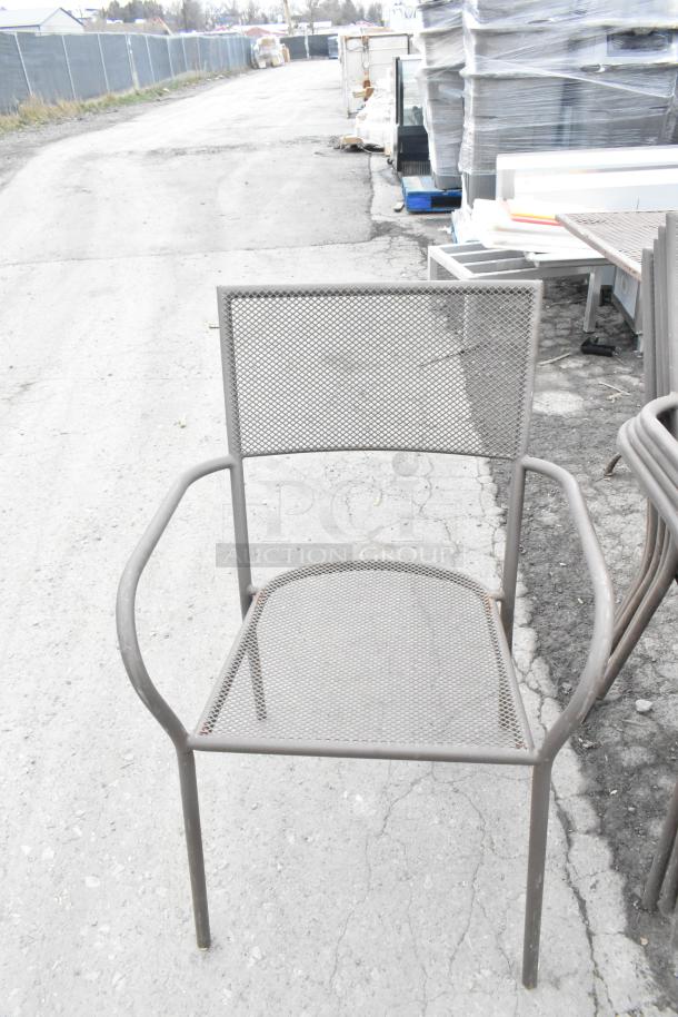 Metal mesh patio armchair, stackable design. Features durable metal frame, suitable for outdoor use. Condition: used.