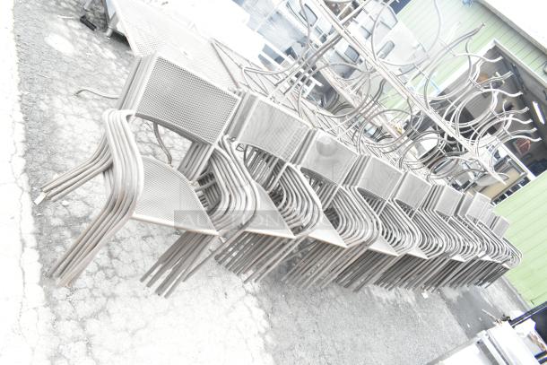 125 metal mesh patio arm chairs stacked, featuring durable construction. Auction includes 125 chairs; bid quantity applies.