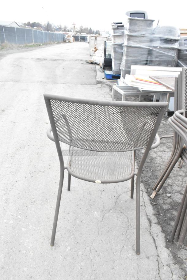 Brown metal mesh patio arm chair, stackable design. Good condition with visible label on the frame. Lot of 125 chairs.