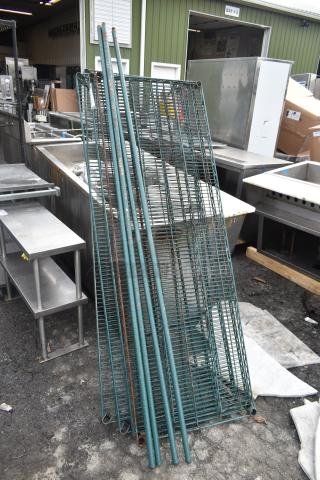 Lot of green wire shelves and poles, showing slight rust. Ideal for storage, functional condition. Auction item.