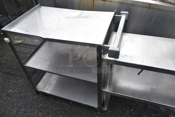 Commercial 3 tier cart with metal shelves on commercial casters, showing signs of use. Ideal for heavy-duty environments.