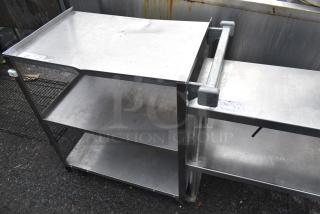 Commercial 3 tier cart with metal shelves on commercial casters, showing signs of use. Ideal for heavy-duty environments.