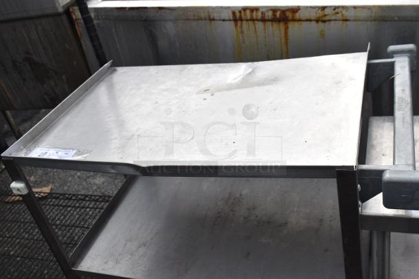 Commercial 3 tier stainless steel cart with commercial casters, showing surface wear and a visible dent on the top shelf.