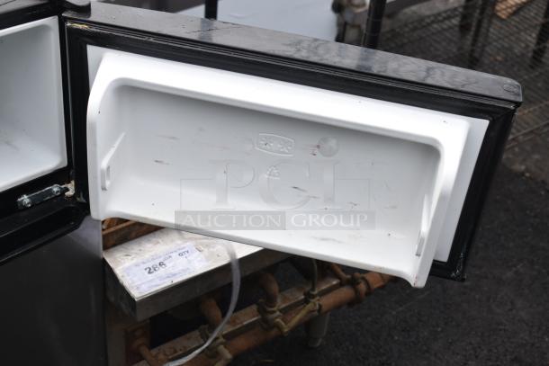 Galanz GLR31TS1E02 mini cooler with freezer, open door view showing interior. Model: GLR31TS1E02. Some wear visible.