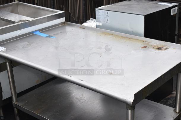 Commercial equipment stand with under shelf, stainless steel, visible wear and scratches, measures approximately 48x30 inches.