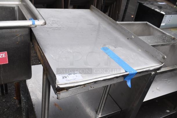 Commercial table with under shelf, stainless steel, moderate wear, visible rust on edges, auction tag with lot number.