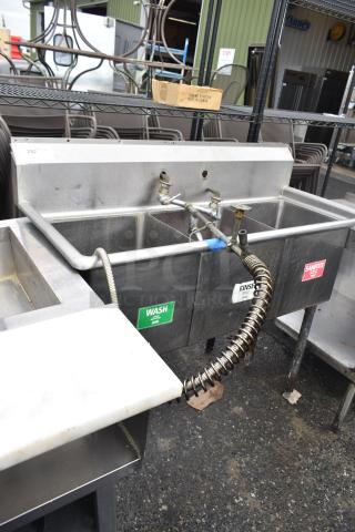 Commercial 3 bay sink with labeled sections: wash, rinse, sanitize. Stainless steel, used condition.