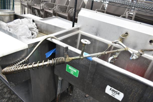 Commercial 3 bay sink with stainless steel construction. Visible wear and labeled sections for wash and rinse.