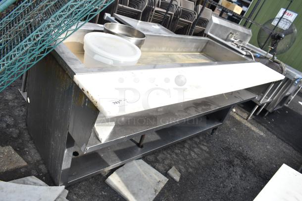 Commercial steam table with stainless steel construction, visible signs of wear, includes storage shelf; item tag 293.