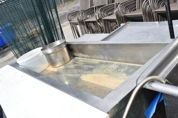 Stainless steel commercial steam table with inset pans, good condition, minor wear visible, suitable for catering use.