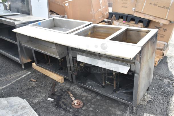 Commercial steam table with three compartments, stainless steel construction, visible wear, suitable for high-volume kitchens.