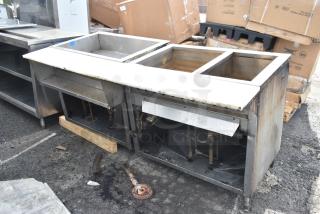 Commercial steam table with three compartments, stainless steel construction, visible wear, suitable for high-volume kitchens.