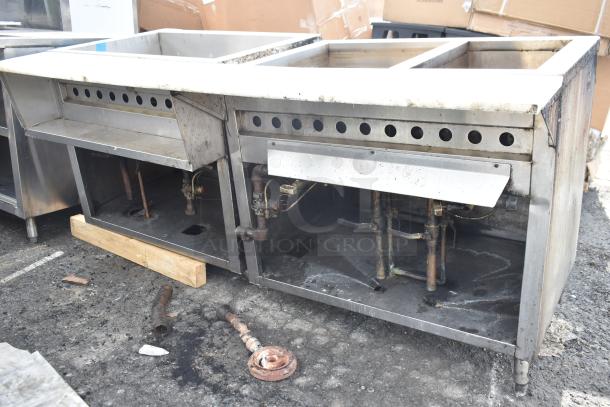 Commercial steam table, stainless steel, three compartments, visible wear and corrosion, plumbing fixtures underneath.