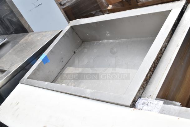 Commercial steam table with stainless steel finish, showing signs of use. Visible label: "294" on the surface.