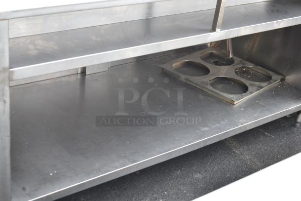 Commercial soda station with under shelf, stainless steel, integrated cup holder, minor surface wear.