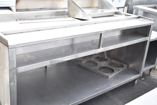 Commercial soda station with under shelf, stainless steel, displays some wear. Ideal for restaurants or cafes.