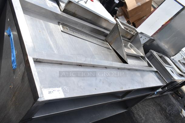 Commercial soda station with under shelf, stainless steel, integrated drainage, storage shelves, minor wear, item tag visible.