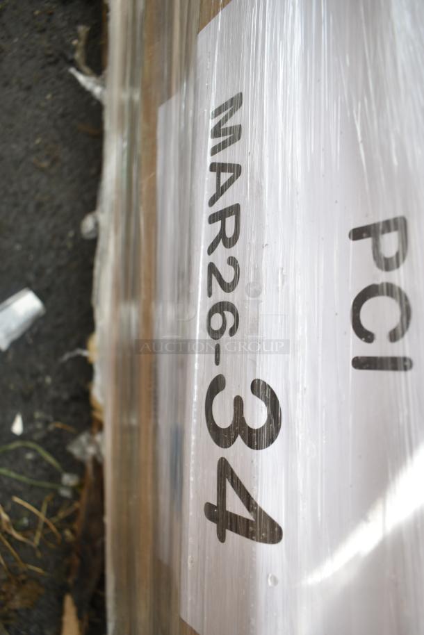 Packaged scratch and dent table base pieces labeled "MAR26-34," brand new, bundled for auction, 15 items in wrap.