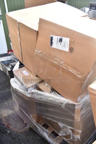 Five scratch and dent items, including over shelf, door frame, and urinal, in new condition, packaged in boxes on a pallet.