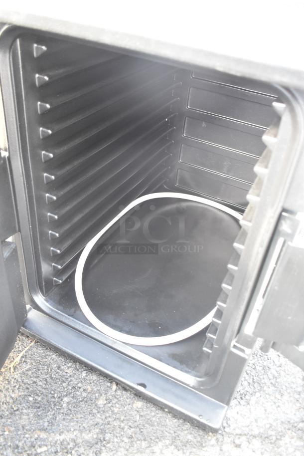 Black poly catering case, brand new with minor dents, shown open displaying interior shelves.