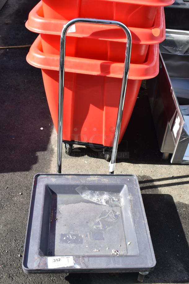 Commercial dolly with a chrome handle and sturdy casters, gray plastic tray, visible wear, tag marked "312."