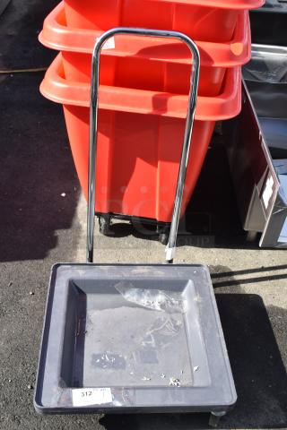 Commercial dolly with a chrome handle and sturdy casters, gray plastic tray, visible wear, tag marked "312."