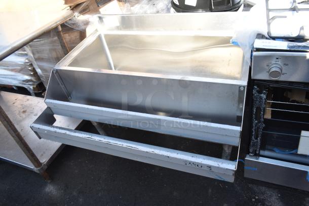 Stainless steel commercial ice bin with double speed well, good condition, visible wear on edges, ideal for high-volume use.
