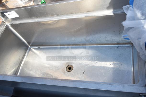 Commercial Ice Bin with Double Speed Well, stainless steel, good condition, minor scratches, drain hole visible.