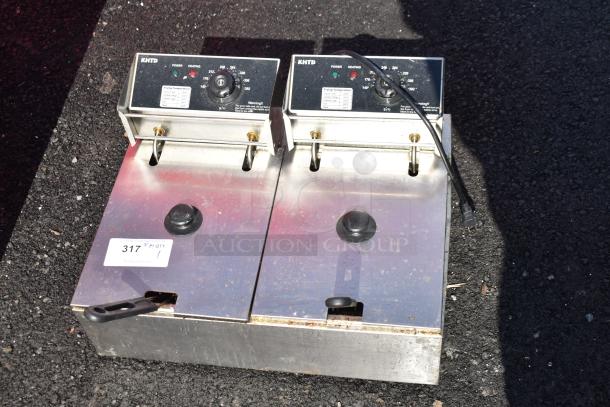Countertop electric 2-bay fryer with 2 metal baskets, lids, 110V, 1-phase, good condition, visible control panel and power cord.