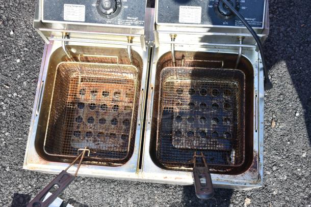 Countertop electric 2 bay fryer with 2 metal fry baskets and lids, 110 volts, 1 phase, showing signs of use.
