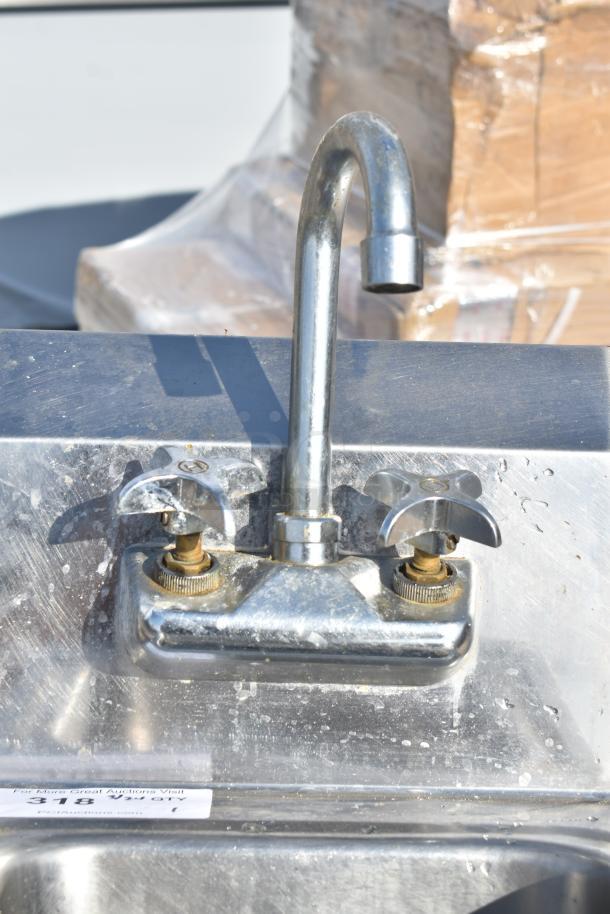 Commercial single bay wall mount sink, stainless steel, dual handles, gooseneck faucet, visible wear, auction label attached.