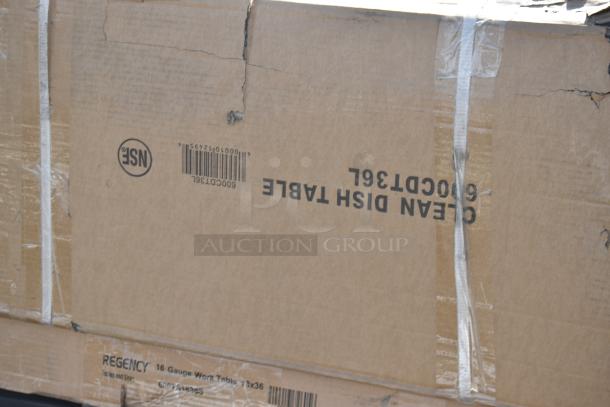 Cardboard box labeled "Clean Dish Table" and "Regency 16 Gauge Work Table." Box shows signs of wear.