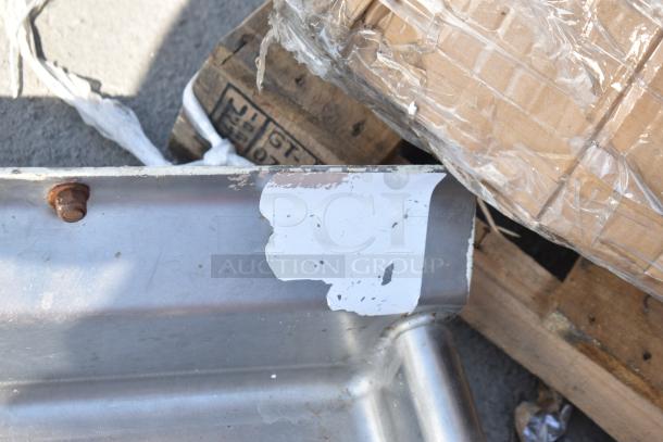 Commercial right side clean side dish table, added drain holes, no legs, visible wear, metal surface.